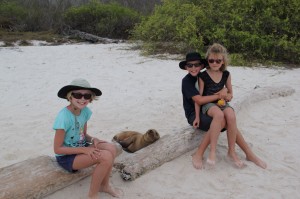 Kids with baby Sea Lion Gardener Bay - Española Island